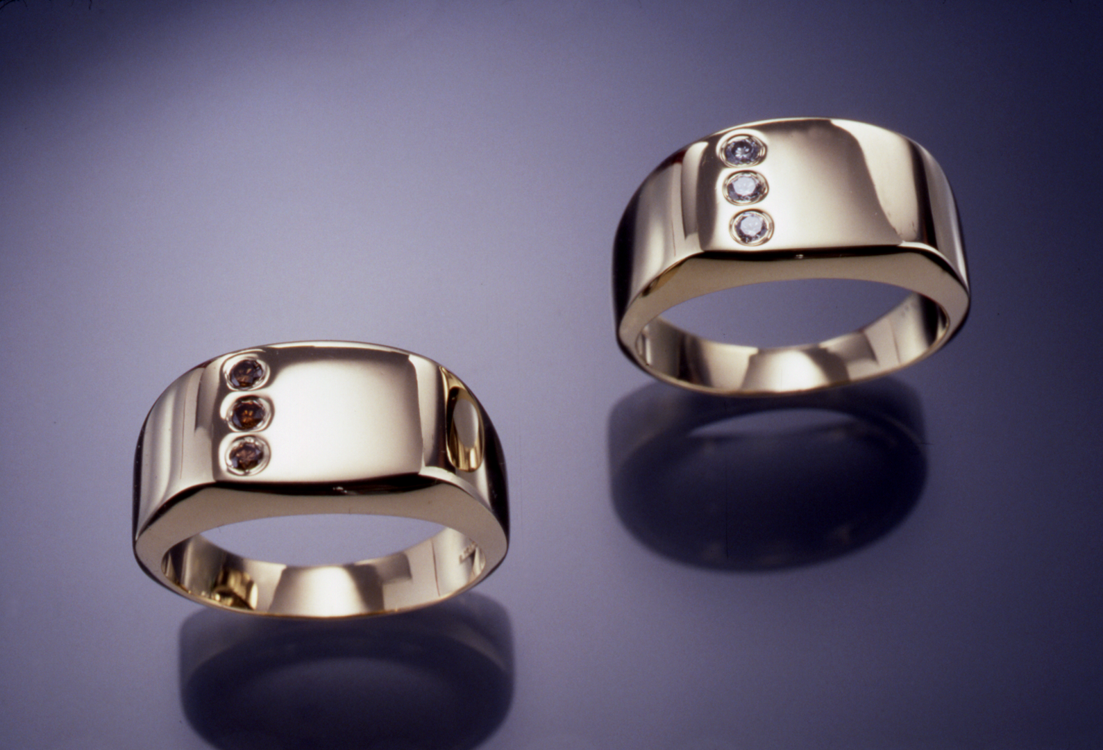 14KT yellow gold gents rings set each set with .15ct. diamonds