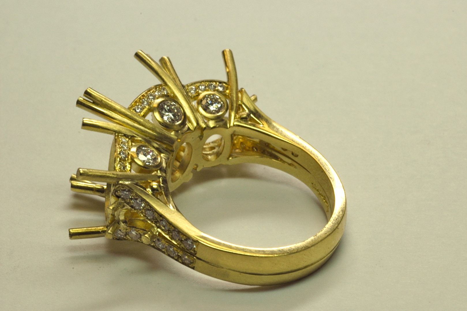 Three Stone RIng in 18KT Yellow Gold before Setting Back View Copyrighted Original by Thomas Michaels Designers, Inc. 18KT yellow gold three stone ring with accent diamonds set