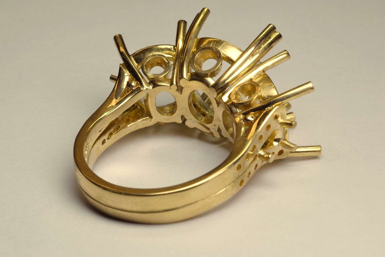 Three Stone RIng in 18KT Yellow Gold before Setting Back View Copyrighted Original by Thomas Michaels Designers, Inc. Three stone ring in 18KT yellow gold before setting back view