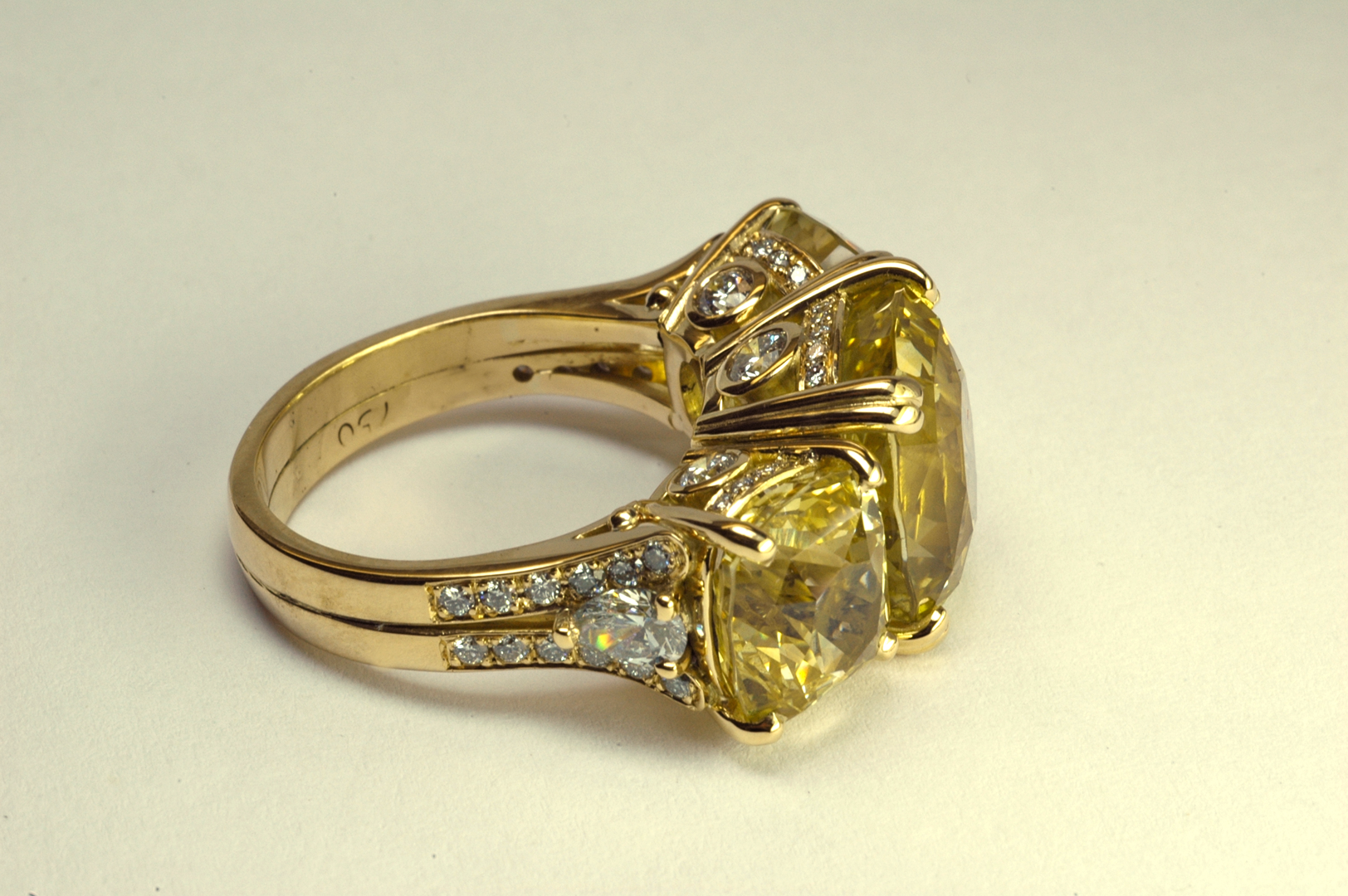 Natural Unheated Yellow Sapphire Three Stone 18KT Yellow Gold Ring, 3/4 View Copyrighted Original by Thomas Michaels Designers, Inc. Yellow sapphire three stone ring with diamond accents