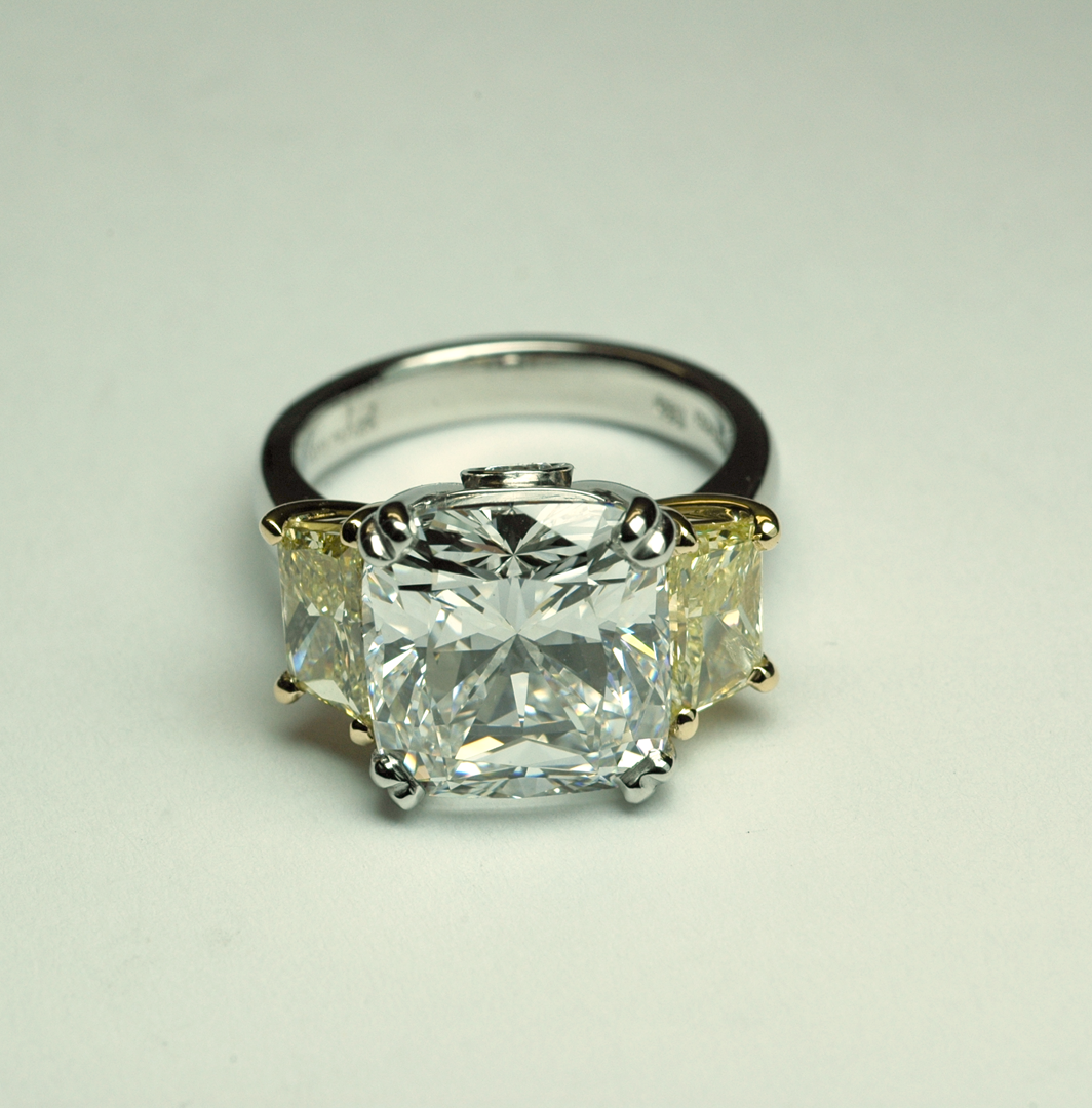 Three stone diamond platinum ring with side yellow diamonds