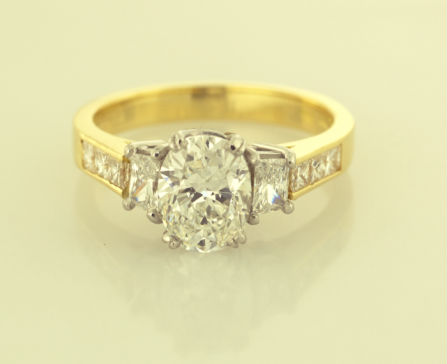 Three Stone Ring set with Oval Center Diamond