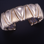 14KT yellow gold flexible cuff bracelet with Luxor motif, titanium inner spring 