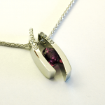 Purple sapphire (3.50ct.) set in 14KT white gold pendant with diamond accents