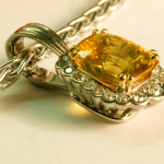 Yellow Sapphire with surround diamonds in 18KT white gold