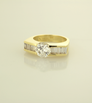 Diamond and 18KT yellow gold ring set with 2.00ct center and 1.20ct. side baguettes
