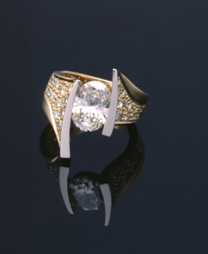Oval diamond (2.50ct.) and gold modern 18KT ring with platinum and diamond pavé accents