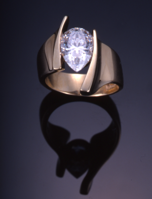 Gold and pear shape (2.00ct.) diamond modern solitaire ring.
