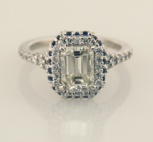 Emerald Cut Diamond Solitaire with Halo of diamonds and sapphires