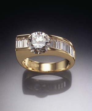 Diamond and 18KT gold ring set with 2.00ct. center with 1.35ct. diamond baguette accents