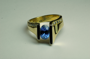 18KT gold and blue oval (1.50ct.) sapphire and diamond ring